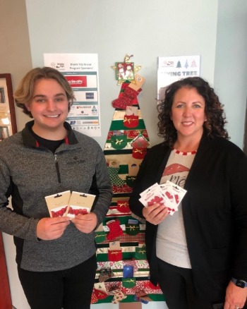 jake groess pictured at community thread with our gift cards from the Holiday Hope drive